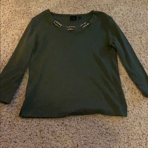 A green blouse with a gold chain collar
